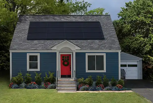 Small blue home with a GAF DecoTech Solar System on its roof